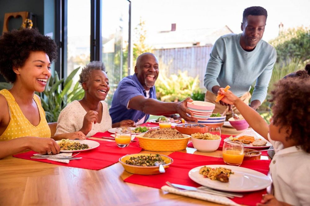 A multi-generational Jamaican family having a meal together