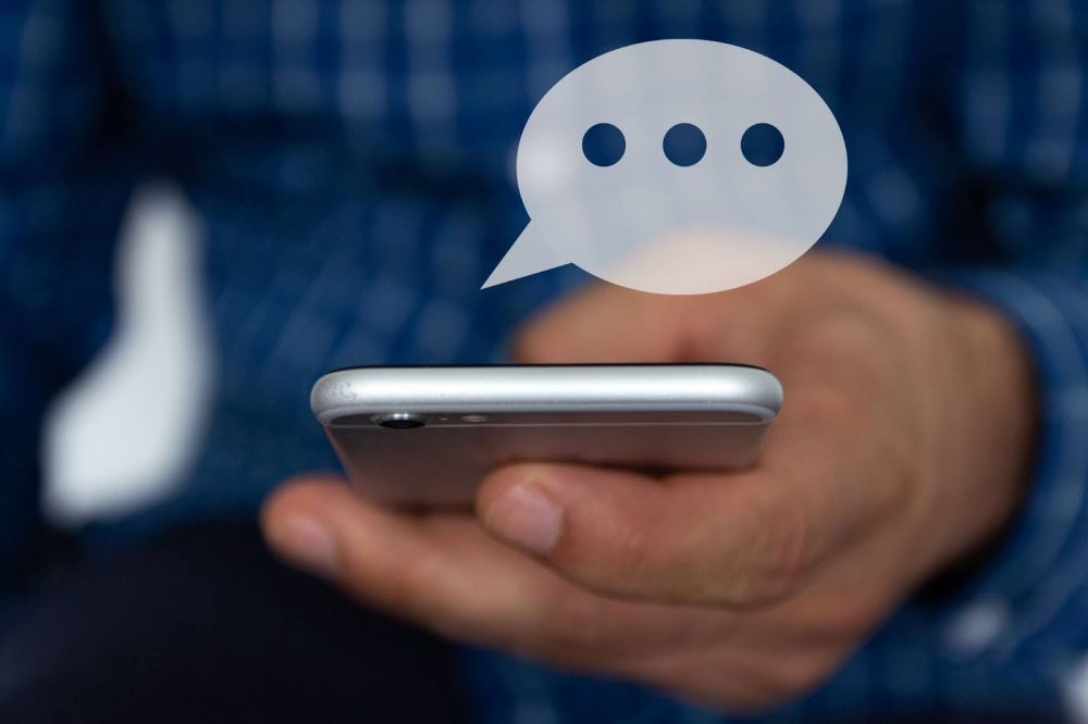 A closeup on a hand of a person typing a text message