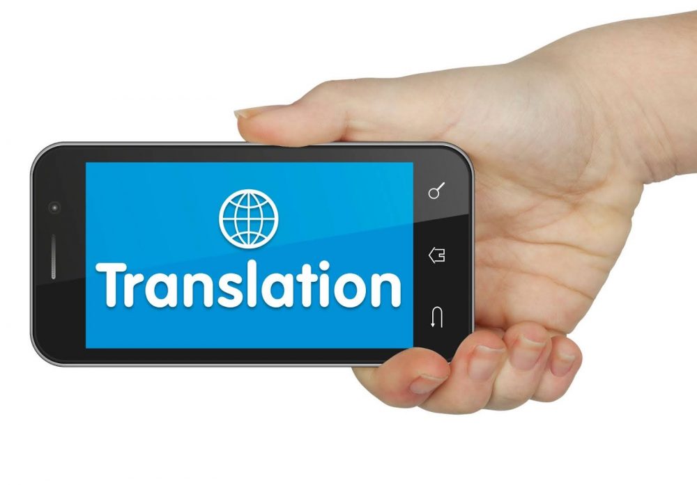 A person holding a phone showing translation